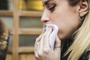 Ung kvinne tørker munnen med serviett